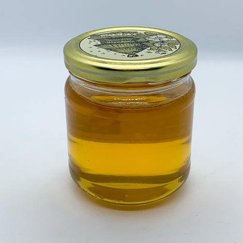 Pot de miel d’acacia pur, couleur dorée et texture fluide, idéal en cuisine et soins naturels.